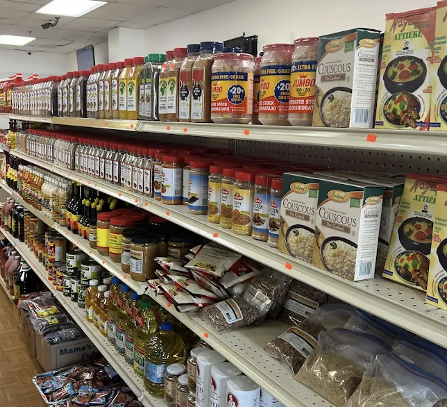 Aisles inside the market stocked with spices, couscous, oils, and African groceries
